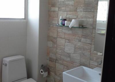 Modern bathroom with tiled wall and fixtures