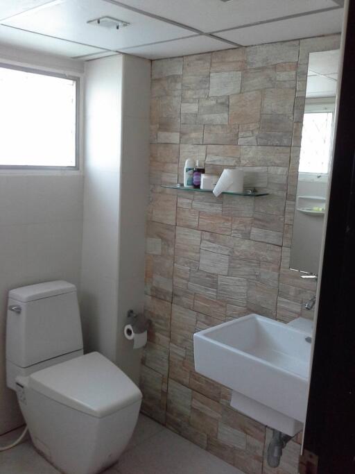 Modern bathroom with tiled wall and fixtures