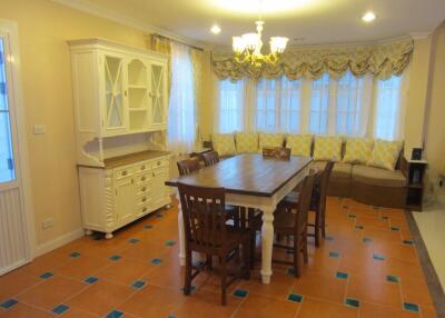 Spacious dining area with large windows and chandelier