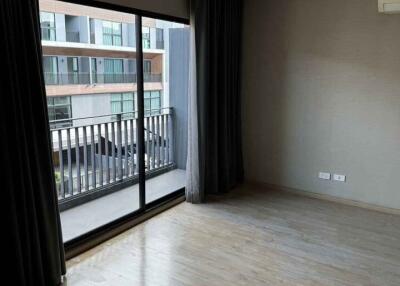 Modern bedroom with large window offering a balcony view