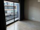 Modern bedroom with large window offering a balcony view