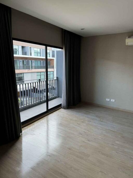 Modern bedroom with large window offering a balcony view