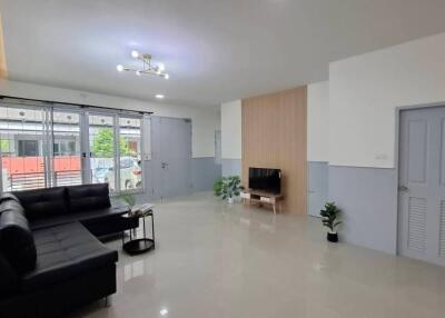 Spacious living room with modern decor and a large window.