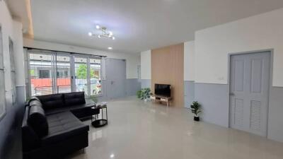 Spacious living room with modern decor and a large window.