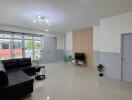 Spacious living room with modern decor and a large window.