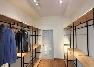 Spacious walk-in closet with hanging and shelving space