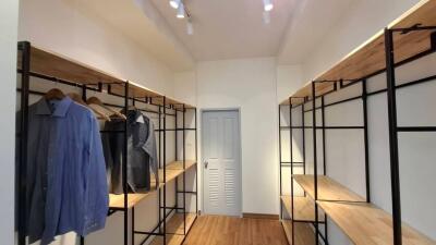 Spacious walk-in closet with hanging and shelving space