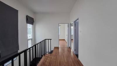 Modern hallway with wooden flooring and natural lighting