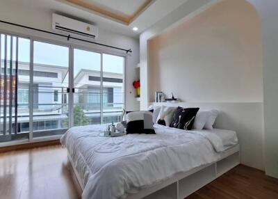 Modern bedroom with large windows and balcony view