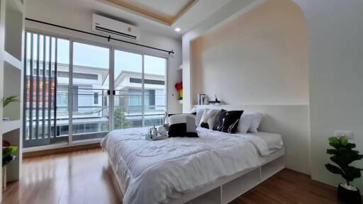 Modern bedroom with large windows and balcony view