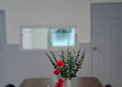 Dining table with decorative centerpiece under pendant lighting