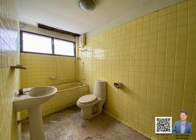 Bathroom with yellow tiles and basic fixtures