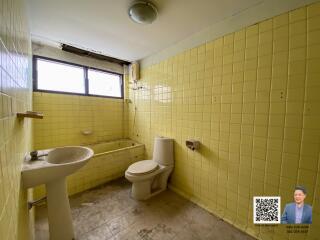 Bathroom with yellow tiles and basic fixtures