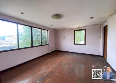 Spacious living room with large windows and wooden flooring