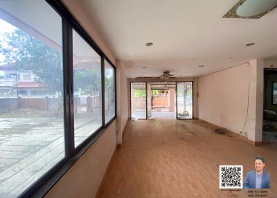 Spacious living room with large windows and outdoor view