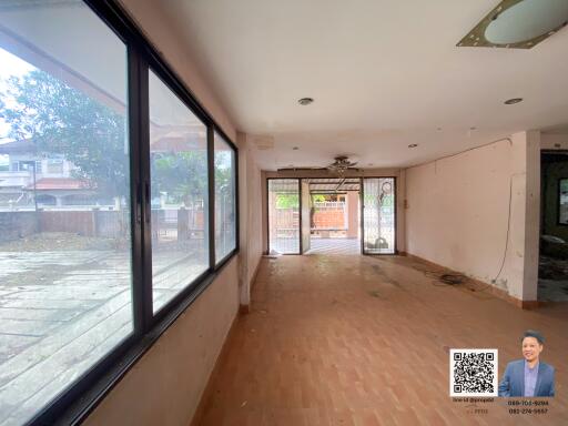 Spacious living room with large windows and outdoor view