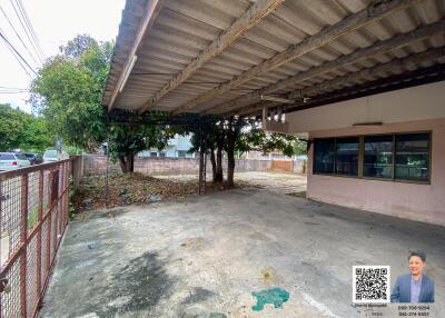 Covered outdoor area with concrete floor and surrounding trees