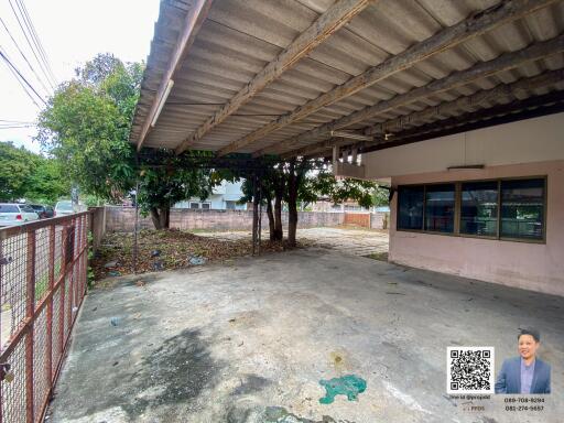 Covered outdoor area with concrete floor and surrounding trees