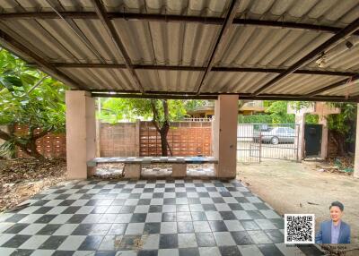 Outdoor covered area with checkerboard floor and seating