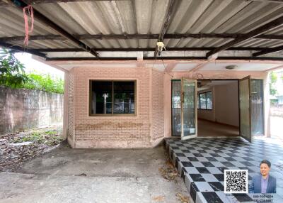 Exterior of a building with an open garage and tiled steps