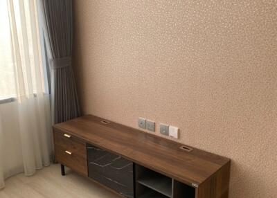 Living room with modern wooden cabinet and patterned wallpaper