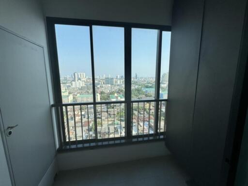 View from a room with large window overlooking cityscape