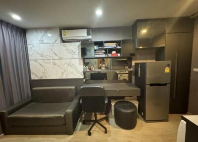 Modern living area with integrated kitchen and work space