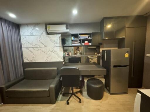 Modern living area with integrated kitchen and work space