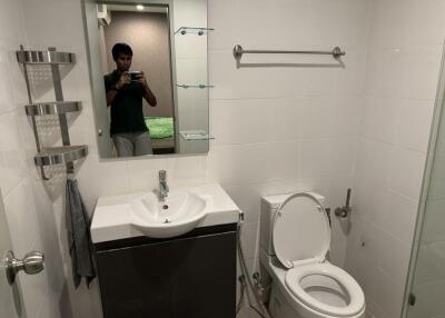 Modern bathroom with sink, toilet, and mirror