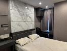 Modern bedroom with marble accent wall and workspace