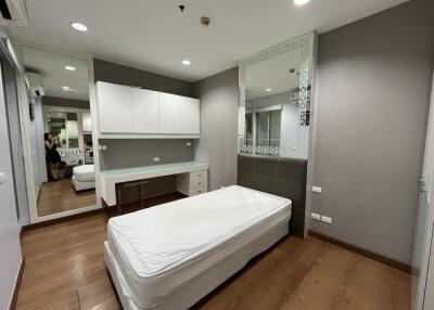 Modern bedroom with built-in desk and large mirrors