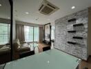 Modern living room with neutral decor, large windows, and wall-mounted shelves