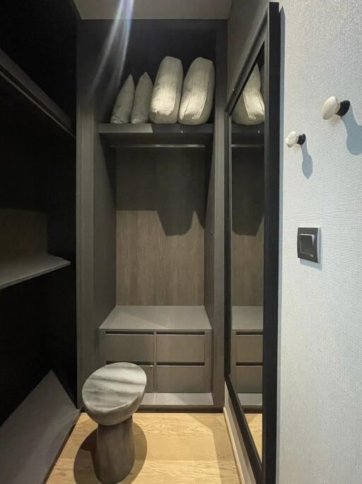 Modern closet with a mirror and small stool