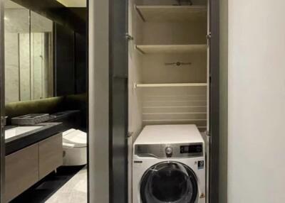 Compact laundry area with washer and shelves