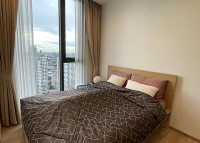 Modern bedroom with large window and city view