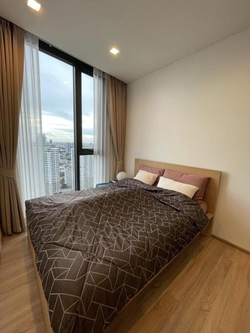 Modern bedroom with large window and city view