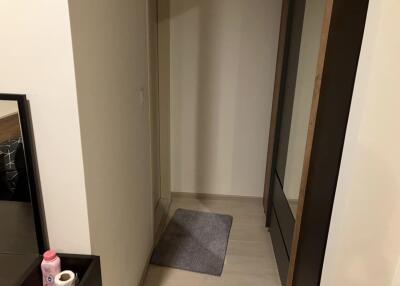 Small hallway with a rug and mirror