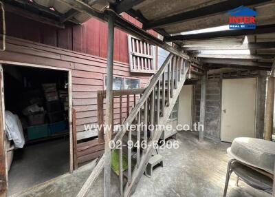 Old wooden building with staircase and storage area