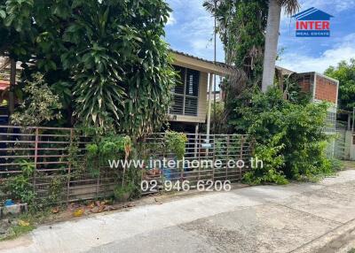 Exterior view of a residential property surrounded by greenery