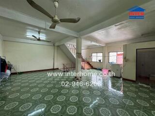 Spacious interior with tiled floor and staircase