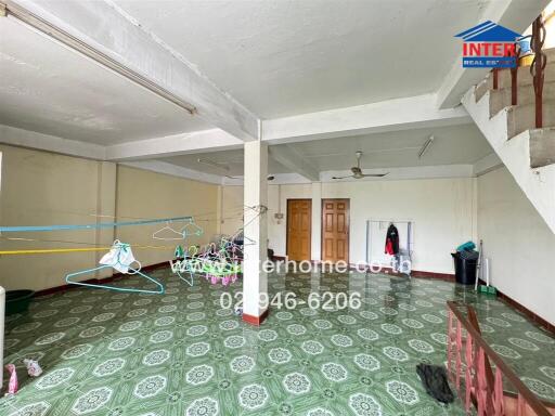 spacious area with tiled flooring and clothing lines