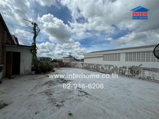 Building rooftop with cloudy sky