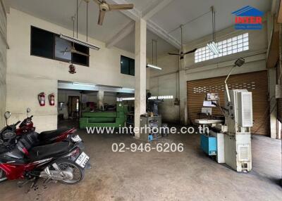 Industrial workshop space with equipment and parked motorbikes