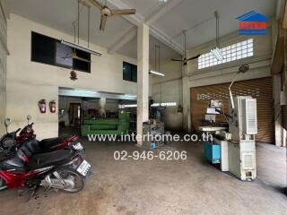 Industrial workshop space with equipment and parked motorbikes