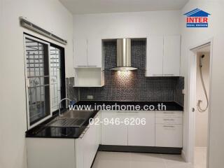 Modern kitchen with tiled backsplash and stainless steel appliances