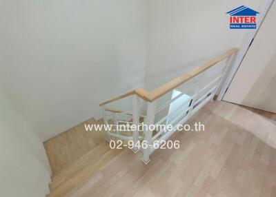 Wooden staircase with white railing