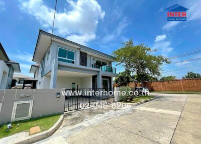 Exterior view of a modern two-story house on a sunny day