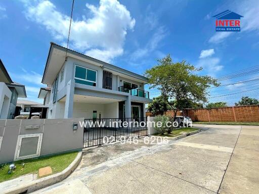 Exterior view of a modern two-story house on a sunny day