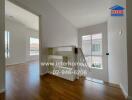 Bright hallway with wooden flooring and large windows