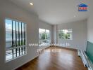 Bright living room with large windows and wooden flooring